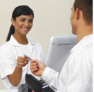 A patient paying for their dentist visit with the receptionist